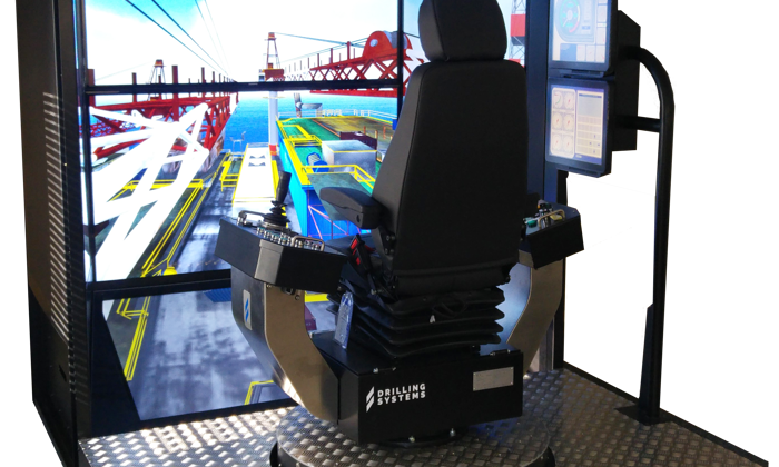 A crane operation simulator with a seat, control panel, and multiple display screens providing a virtual construction site view for training purposes.