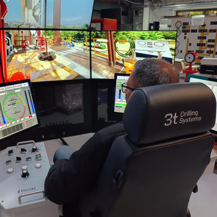 Rear view of chair with man sitting in it using drilling simulator technology